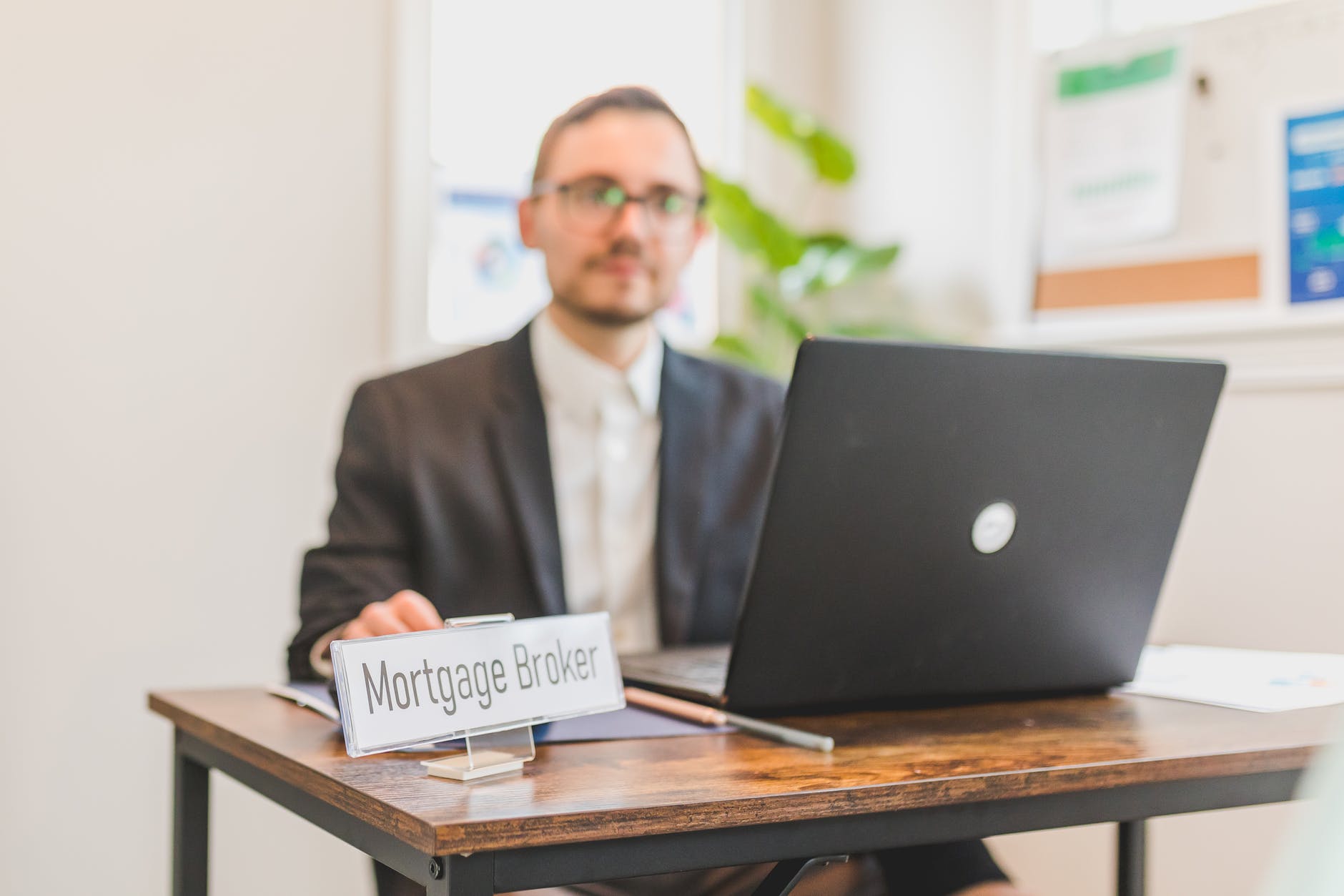 a mortgage broker sitting behind a desk